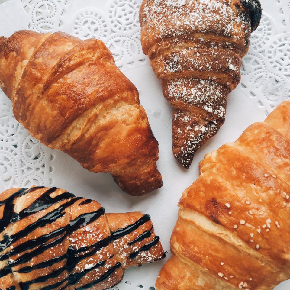 Assortment of buttery croissants on a doily