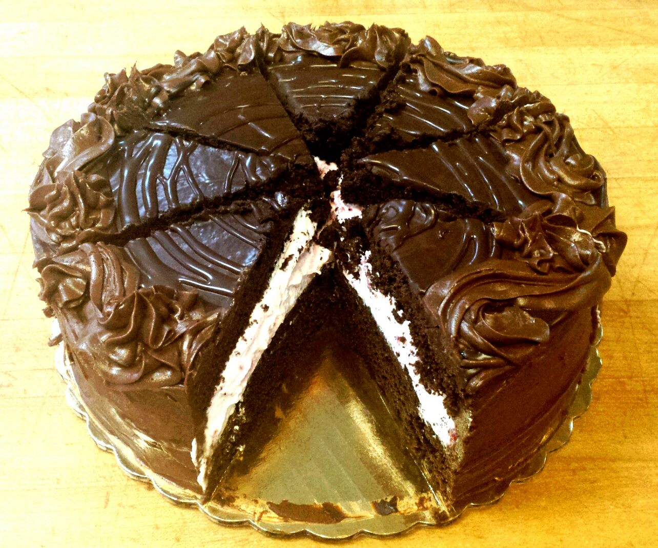 Sliced chocolate cake with rich ganache frosting